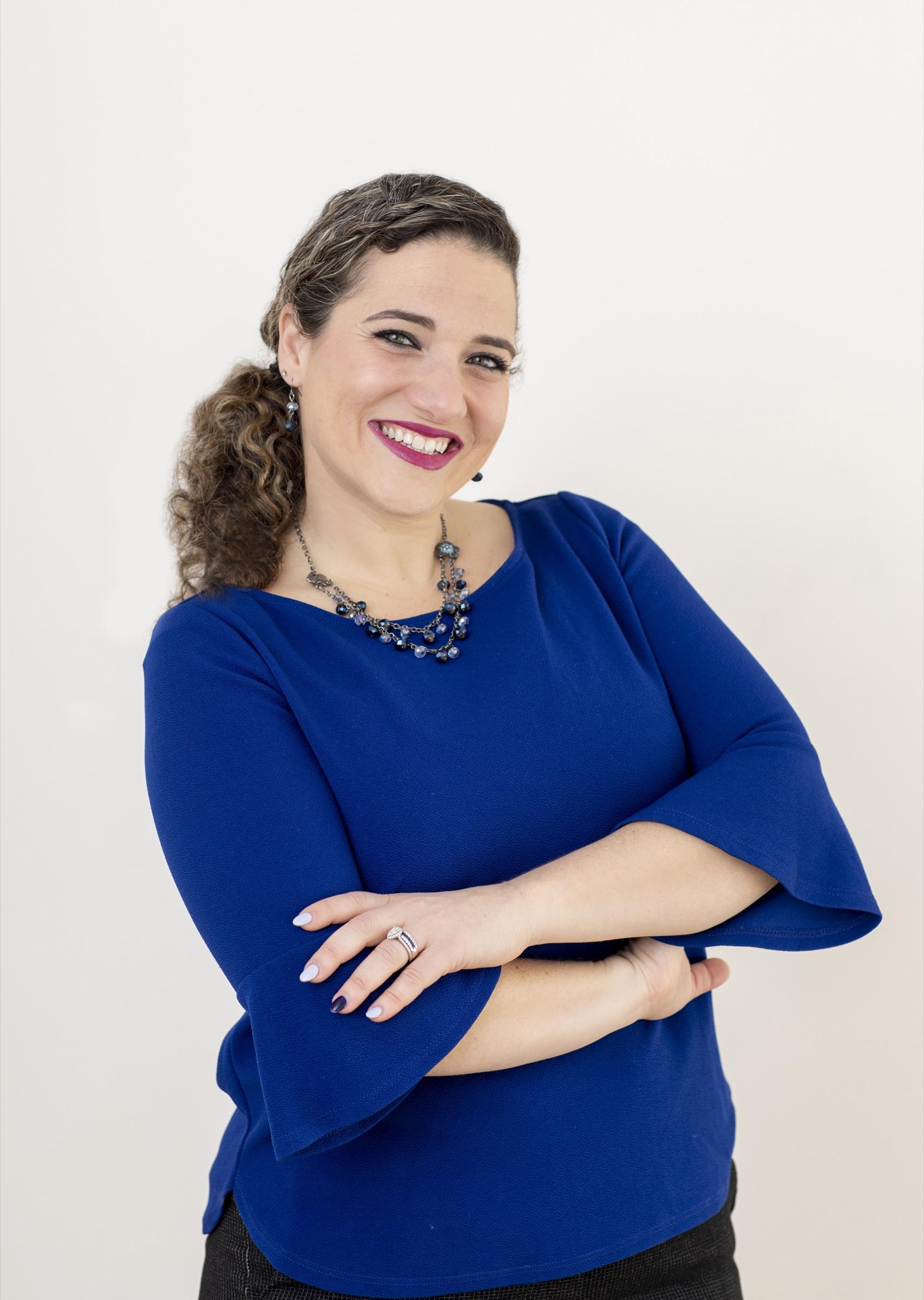 Nicole Stephenson studio headshot in a royal blue top.